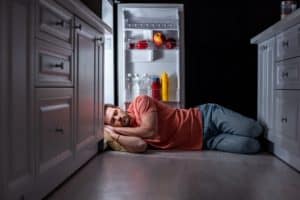 With the current rising of temperatures, the man sleeping on the fridge symbolize the ease from heat and bed bugs from his bed.
